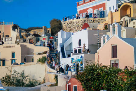 Santorini Island, Oia, Greece - October 23, 2021 Cityscape of the town of Oia, the small traditional white houses typical of this island are perched on the side of the ancient active volcanoのeditorial素材