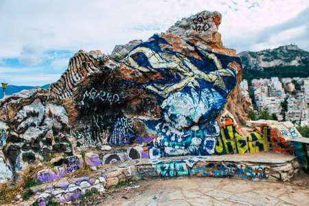 Athens, Greece - November 20, 2021 StrÃ©fi Hill is an urban nature park covered in tags and messages made by anarchist artists, located in the district of Exarcheia, considered the rebel area of Athensのeditorial素材
