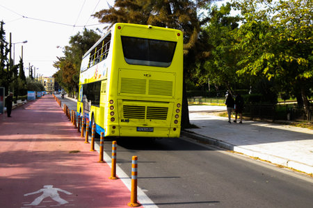 Athens, Greece - November 22, 2021 Tourist bus driving through the streets of Athens during the coronavirus outbreak hitting Greece, wearing a mask is mandatoryのeditorial素材