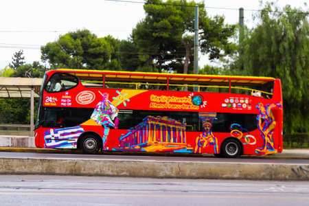 Athens, Greece - November 22, 2021 Tourist bus driving through the streets of Athens during the coronavirus outbreak hitting Greece, wearing a mask is mandatoryのeditorial素材