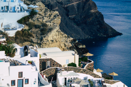 Santorini Island, Oia, Greece - October 23, 2021 Cityscape of the town of Oia, the small traditional white houses typical of this island are perched on the side of the ancient active volcanoのeditorial素材