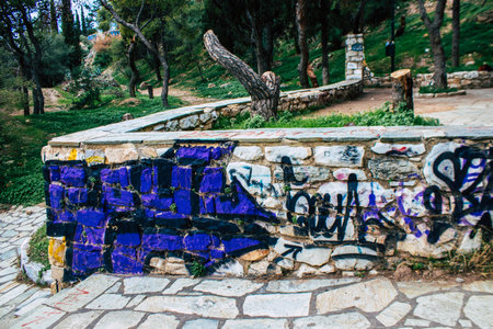 Athens, Greece - November 20, 2021 StrÃ©fi Hill is an urban nature park covered in tags and messages made by anarchist artists, located in the district of Exarcheia, considered the rebel area of Athensのeditorial素材
