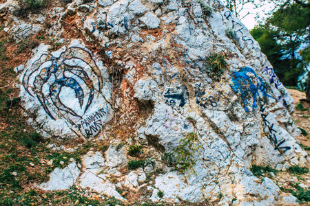 Athens, Greece - November 20, 2021 StrÃ©fi Hill is an urban nature park covered in tags and messages made by anarchist artists, located in the district of Exarcheia, considered the rebel area of Athensのeditorial素材