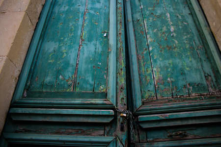 Limassol, Cyprus - December 03, 2021 Detailed close-up of an old door totally damaged by the weather of an old house in the old district of Limassol in Cyprusの写真素材