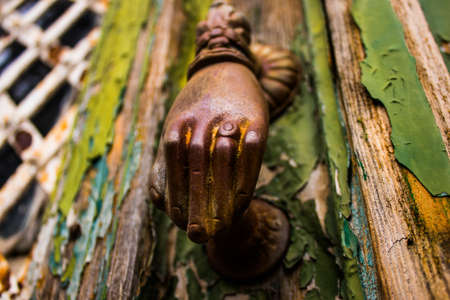 Limassol, Cyprus - December 03, 2021 Detailed close-up of an old door totally damaged by the weather of an old house in the old district of Limassol in Cyprusの写真素材