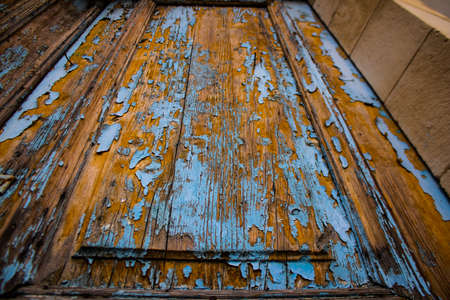 Limassol, Cyprus - December 03, 2021 Detailed close-up of an old door totally damaged by the weather of an old house in the old district of Limassol in Cyprusの写真素材