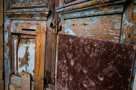 Limassol, Cyprus - December 03, 2021 Detailed close-up of an old door totally damaged by the weather...
