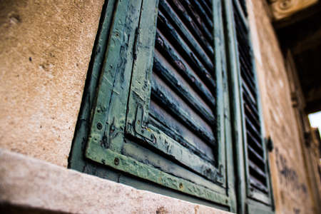 Limassol, Cyprus - December 03, 2021 Detailed close-up of an old window totally damaged by the weather of an old house in the old district of Limassol in Cyprusの写真素材