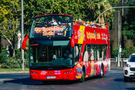Seville Spain August 28, 2021 Tourist bus driving through the streets of Seville during the coronavirus outbreak hitting Spain, wearing a mask is mandatoryのeditorial素材