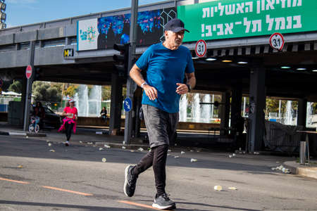 Tel Aviv, Israel - February 25, 2022 Runners in the street of Tel Aviv at the Samsung Marathon which takes place on February 25 after a year-long hiatus following the coronavirus outbreak in Israelのeditorial素材