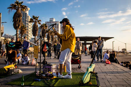 Tel Aviv, Israel - March 06, 2022 Young independent singer doing a music concert on the promenade...