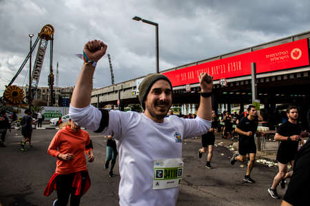 Tel Aviv, Israel - February 25, 2022 Runners in the street of Tel Aviv at the Marathon which takes...