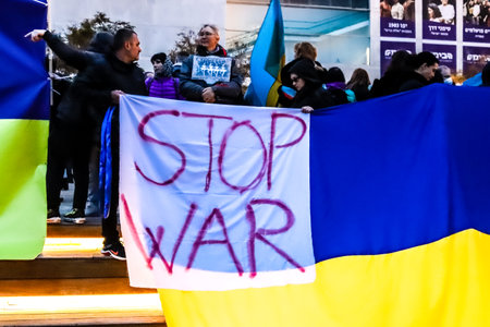 Tel Aviv, Israel - March 20, 2022 Protesters against Russian policy towards Ukraine in Habima Square in Tel Aviv, Israelis support the Ukrainian people in the war that has broken out against Russiaのeditorial素材