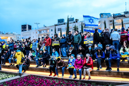 Tel Aviv, Israel - March 20, 2022 Protesters against Russian policy towards Ukraine in Habima Square in Tel Aviv, Israelis support the Ukrainian people in the war that has broken out against Russiaのeditorial素材