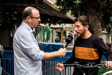 Tel Aviv, Israel - April 08, 2022 Following the Palestinian terrorist attack at the Ilka Bar on Dizengoff Street, journalists reporting the events of last nightのeditorial素材