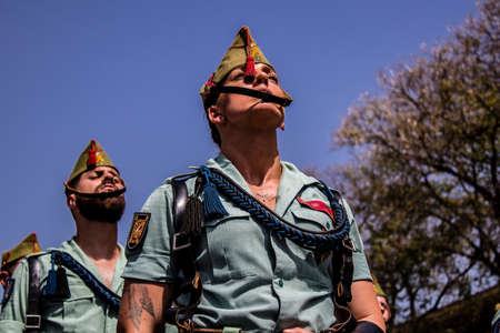 Seville, Spain - May 01, 2022 Parade of professional soldiers from the Spanish Legion, this military unit of the Spanish Army parade through the streets of Seville for the launch of the Feriaの写真素材
