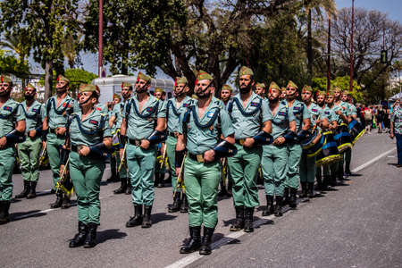 Seville, Spain - May 01, 2022 Parade of professional soldiers from the Spanish Legion, this military...