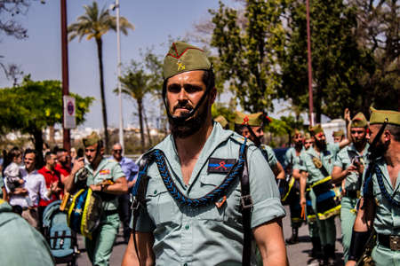 Seville, Spain - May 01, 2022 Parade of professional soldiers from the Spanish Legion, this military unit of the Spanish Army parade through the streets of Seville for the launch of the Feriaのeditorial素材