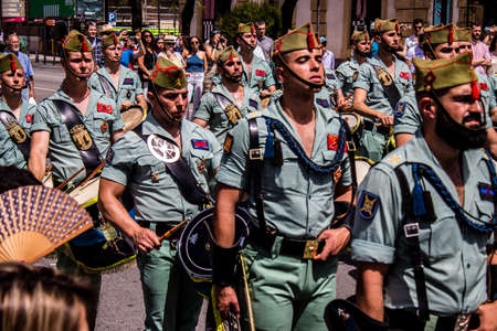Seville, Spain - May 01, 2022 Parade of professional soldiers from the Spanish Legion, this military...