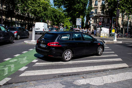 Paris, France - May 21, 2022 Taxi driving through the streets of Paris during the coronavirus outbreak hitting France, wearing a mask is mandatoryのeditorial素材