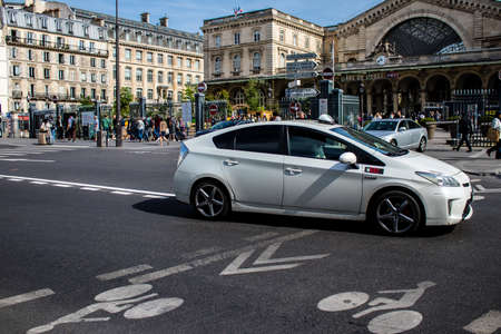 Paris, France - May 21, 2022 Taxi driving through the streets of Paris during the coronavirus outbreak hitting France, wearing a mask is mandatoryのeditorial素材