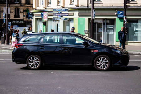 Paris, France - May 21, 2022 Taxi driving through the streets of Paris during the coronavirus outbreak hitting France, wearing a mask is mandatoryのeditorial素材