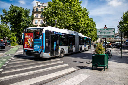 Paris, France - May 21, 2022 Bus driving through the streets of Paris during the coronavirus outbreak hitting France, wearing a mask is mandatoryのeditorial素材