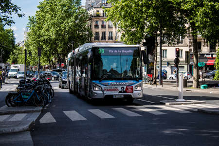 Paris, France - May 21, 2022 Bus driving through the streets of Paris during the coronavirus outbreak hitting France, wearing a mask is mandatoryのeditorial素材