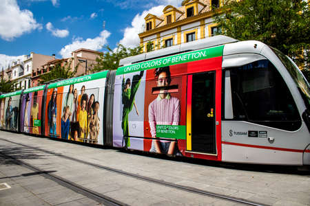 Seville, Spain - May 21, 2022 Modern electric tram for passengers rolling through the streets of Seville during the coronavirus outbreak hitting Spain, wearing a mask is mandatoryのeditorial素材
