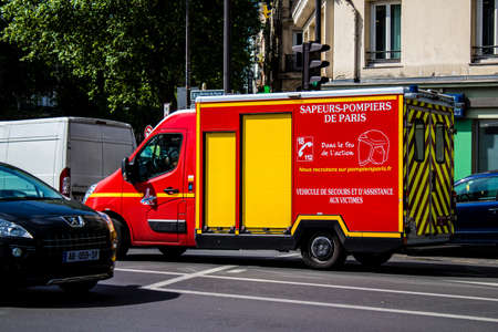 Paris, France - May 21, 2022 Fire engine driving through the streets of Paris during the coronavirus...