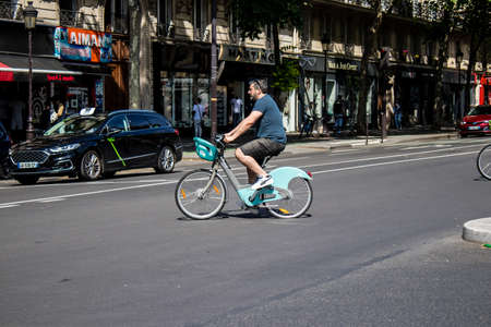 Paris, France - May 21, 2022 People rolling with a bicycle in the streets of Paris during the...