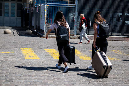 Paris, France - May 21, 2022 Tourists walking in the streets of Paris near the train station during...