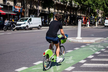 Paris, France - May 21, 2022 People rolling with a bicycle in the streets of Paris during the...
