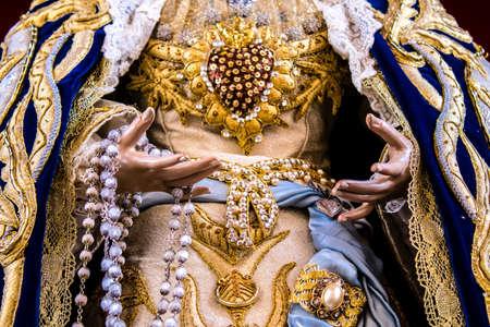 Carmona, Spain - June 19, 2022 Corpus Christi de Carmona, religious procession through the streets to Santa Maria Church, made up of religious statues, young children, christians and a music bandのeditorial素材