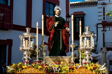 Carmona, Spain - June 19, 2022 Corpus Christi de Carmona, religious procession through the streets to Santa Maria Church, made up of religious statues, young children, christians and a music bandのeditorial素材