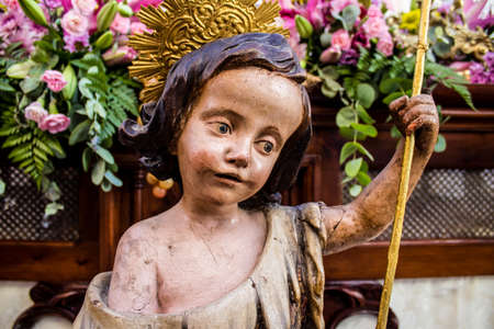 Carmona, Spain - June 19, 2022 Corpus Christi de Carmona, religious procession through the streets to Santa Maria Church, made up of religious statues, young children, christians and a music bandのeditorial素材