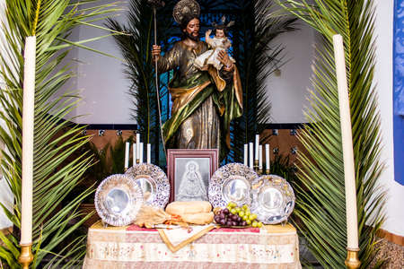 Carmona, Spain - June 19, 2022 Corpus Christi de Carmona, religious procession through the streets to Santa Maria Church, made up of religious statues, young children, christians and a music bandのeditorial素材
