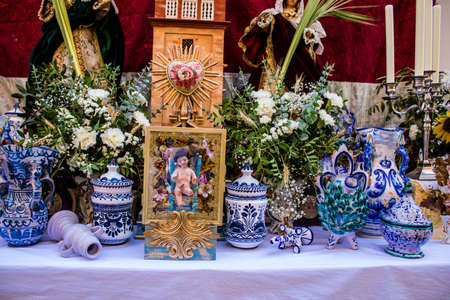 Carmona, Spain - June 19, 2022 Corpus Christi de Carmona, religious procession through the streets to Santa Maria Church, made up of religious statues, young children, christians and a music bandのeditorial素材