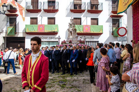 Carmona, Spain - June 19, 2022 Corpus Christi of Carmona, religious procession through the streets to Santa Maria Church, made up of religious statues, young children, christians and a music bandのeditorial素材