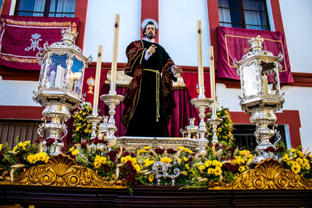 Carmona, Spain - June 19, 2022 Corpus Christi de Carmona, religious procession through the streets to Santa Maria Church, made up of religious statues, young children, christians and a music bandのeditorial素材