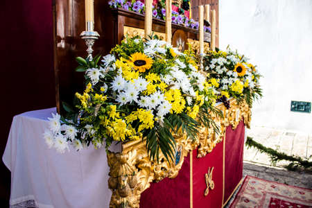 Carmona, Spain - June 19, 2022 Corpus Christi de Carmona, religious procession through the streets to Santa Maria Church, made up of religious statues, young children, christians and a music bandのeditorial素材