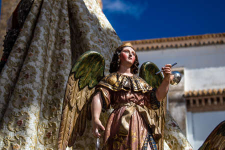 Carmona, Spain - June 19, 2022 Corpus Christi of Carmona, religious procession through the streets to Santa Maria Church, made up of religious statues, young children, christians and a music bandのeditorial素材
