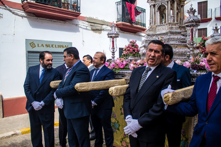 Carmona, Spain - June 19, 2022 Corpus Christi of Carmona, religious procession through the streets to Santa Maria Church, made up of religious statues, young children, christians and a music bandのeditorial素材