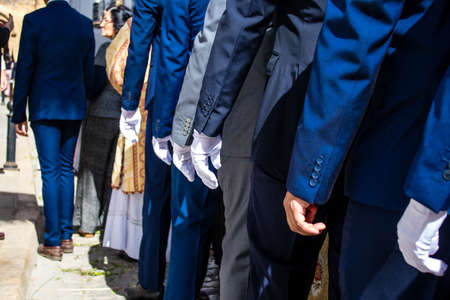 Carmona, Spain - June 19, 2022 Corpus Christi of Carmona, religious procession through the streets to Santa Maria Church, made up of religious statues, young children, christians and a music bandのeditorial素材