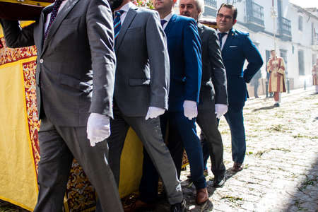 Carmona, Spain - June 19, 2022 Corpus Christi of Carmona, religious procession through the streets to Santa Maria Church, made up of religious statues, young children, christians and a music bandのeditorial素材