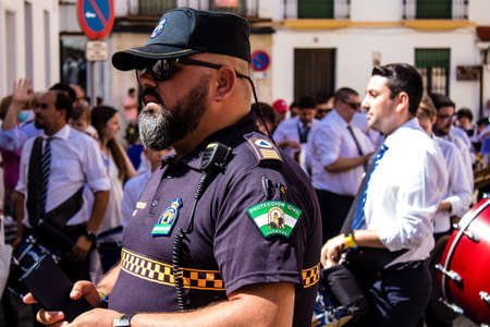 Carmona, Spain - June 19, 2022 Corpus Christi of Carmona, religious procession through the streets to Santa Maria Church, made up of religious statues, young children, christians and a music bandのeditorial素材