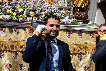 Carmona, Spain - June 19, 2022 Corpus Christi of Carmona, religious procession through the streets to Santa Maria Church, made up of religious statues, young children, christians and a music bandのeditorial素材