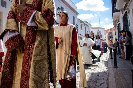 Carmona, Spain - June 19, 2022 Corpus Christi of Carmona, religious procession through the streets to Santa Maria Church, made up of religious statues, young children, christians and a music bandのeditorial素材