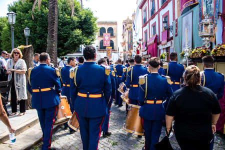 Carmona, Spain - June 19, 2022 Corpus Christi of Carmona, religious procession through the streets to Santa Maria Church, made up of religious statues, young children, christians and a music bandのeditorial素材