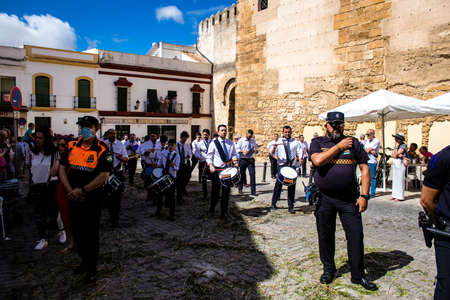 Carmona, Spain - June 19, 2022 Corpus Christi of Carmona, religious procession through the streets to Santa Maria Church, made up of religious statues, young children, christians and a music bandのeditorial素材